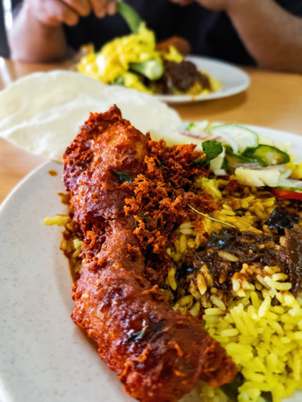 Nasi kandar the most popular dish in Penang, Malaysia. White rice with okra, curry sauce and fried chickenの写真素材