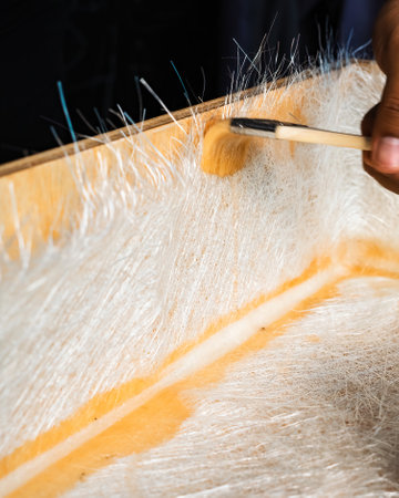 Brushing solution through fiberglass sheets on a wooden box. A diy project at home.の写真素材