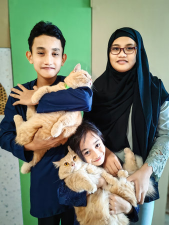 Family and Siblings concept celebrating eid fitr. Asian Malay Muslim greetings during Hari Raya Aidilfitri. Malaysian people living lifestyle.の写真素材