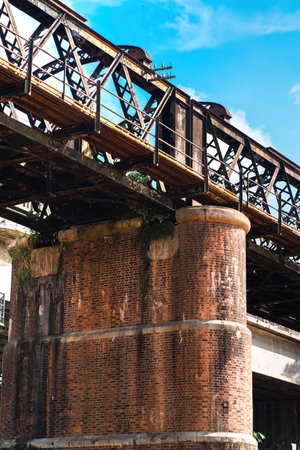 A large brick and stone masonry arch bridge over the Kuala Kangsar river in Malaysia.