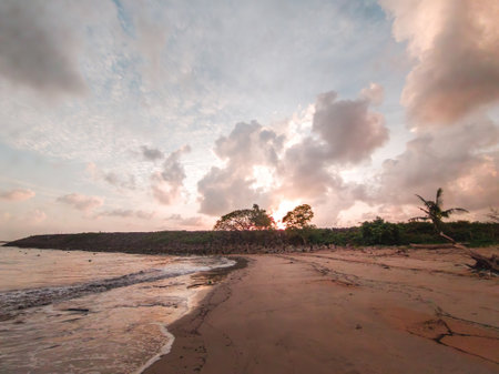 Low angle view of beautiful sunrise by the beach in Besut, Terengganu, Malaysia.の写真素材
