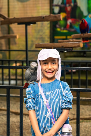 Happy child with African Grey Parrot - Psittacus erithacus.の写真素材
