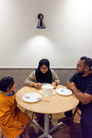 Asian family celebrating birthday together at home.の写真素材