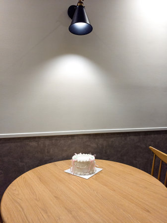vintage cake with pink bows of delicate cream color on a table in a room.の写真素材
