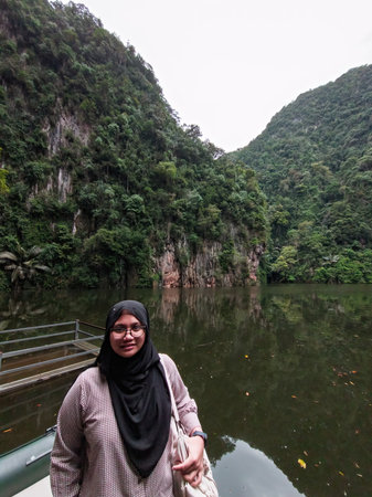 Hijab girl is at the beautiful Tasik Cermin lake.の写真素材