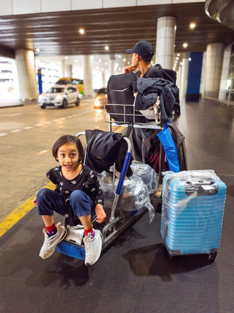 Family waiting at the drop off area at KLIA International Airport.の写真素材