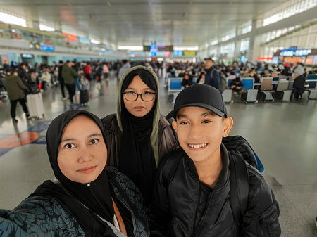Muslim family self portrait during traveling at the railway station in China.の写真素材