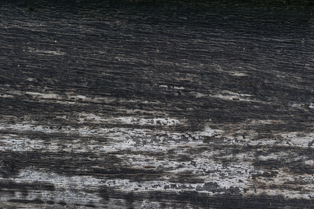 Close-up of an old faded black and grey plank.の写真素材