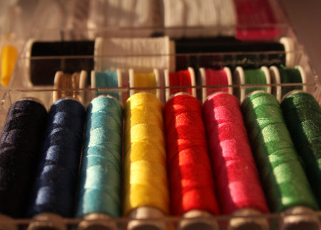 Set of colorful threads lined up in boxes. Background with tailor threads in all basic bars.の写真素材