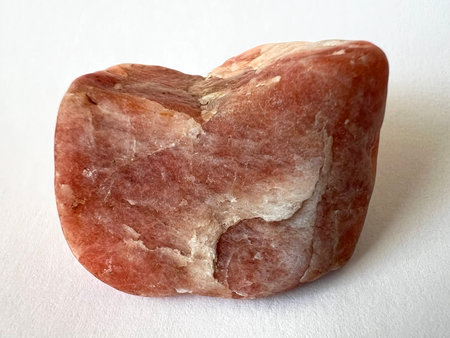 Red Triplite stone, object on white background. Rare phosphate monoclinic mineral, top quality used in jewelry as a gemstone.の写真素材