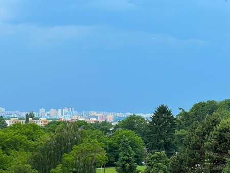 Suburbs of the capital city Prague, Czech Republic. View across the forest to the panorama of the Prague housing estate in storm haze.の写真素材