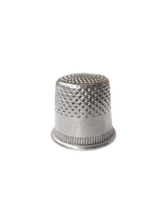 Metallic thimble with the scratches by the needle. Object over white.の写真素材