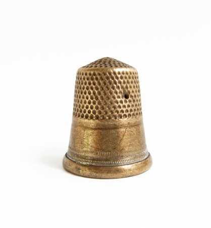 Brazen thimble with the scratches by the needle.