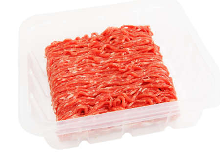Plastic packaging with raw ground beef isolated on white bachgroundの写真素材