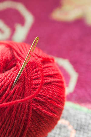 A ball of red yarn to the needleの写真素材