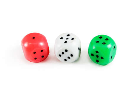 Three dices - red, white and green color isolated on white backgroundの写真素材