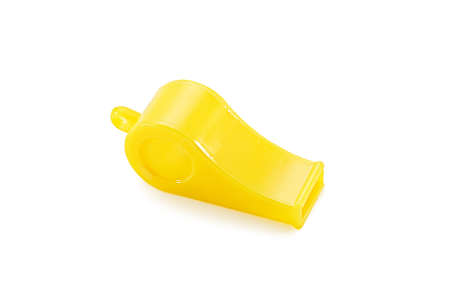 Yellow plastic whistle isolated on white backgroundの写真素材