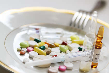 Course of medical treatment on dinner plateの写真素材