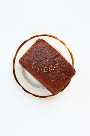 Loaf of black bread on  china plateの写真素材
