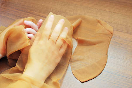 Retro nylon stockings in hands of a young girl