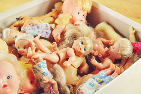 Old dolls and other toys in the pasteboard box