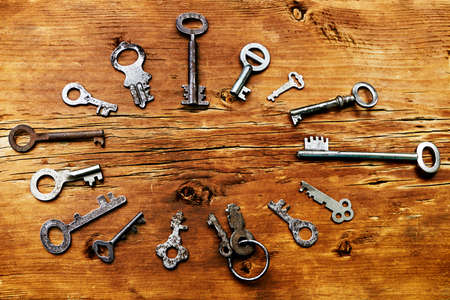 Retro keys on wooden board as a backgroundの写真素材