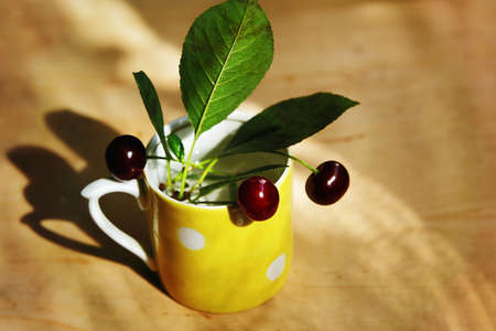 Cherries in the yellow cup