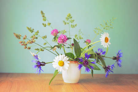 Bouquet of wildflowers in the white cupの写真素材