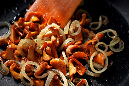 Fried mushrooms chanterelles with onion in oilの写真素材
