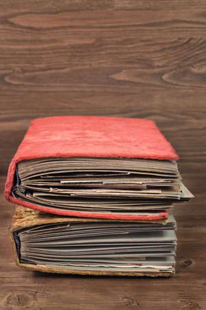 Two vintage thick photoalbums in the plush covers with text space on wooden backgroundの写真素材