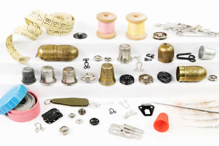 Various vintage accessories and tools for sewing on white stairs