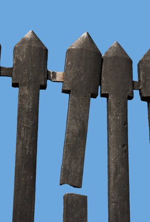 Broken cast iron vintage fence of a fortress isolated on blueの写真素材