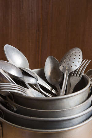 Vintage aluminum kitchen utensils, pan, metal cooking pots, spoons, forksの写真素材