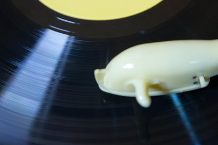 Rotation of old vinyl disk in player with plastic adapter 1960s
