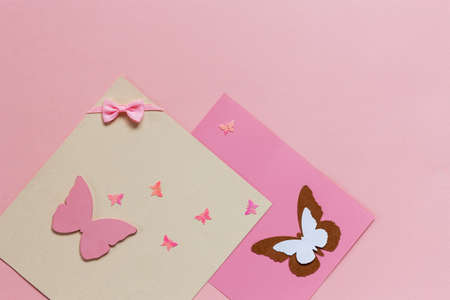 
Butterfliy figyrines on the pink paper background	の写真素材