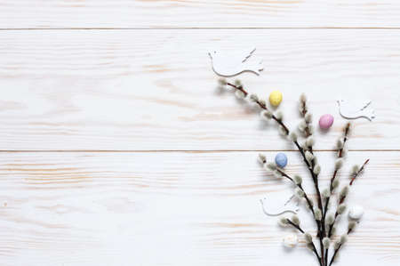 Easter decoration â€“ pattern of colorful decorative eggs and dove figurines on pussy willow...