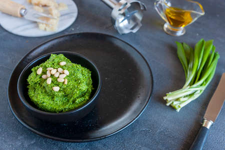 Fresh homemade wild garlic pesto made with Bear Leek herbs,  delicious savory sauce for Italian pasta and ingredients for its cookingの写真素材