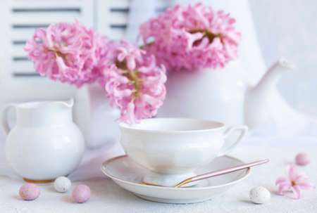 Fresh beautiful bouquet of pink hyacinths and a cup of coffee - breakfast for Mother's Day, Easter