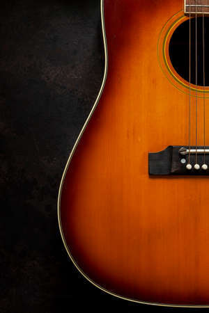 Acoustic guitar  on dark brown backgroundの写真素材