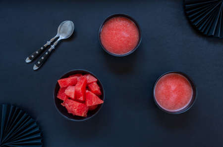 Top view of fresh iced homemade watermelon sorbet, granita, smoothie on black backgroundの写真素材
