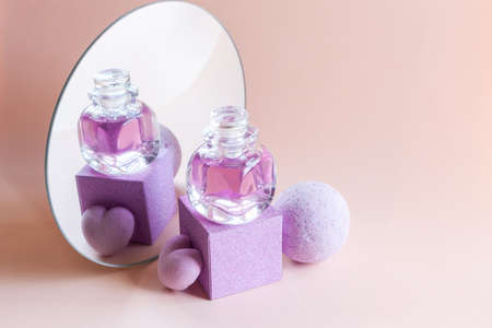 Lavender soap, shampoo and aromatic bath bomb with reflection in a round mirror. Concept for spa,...