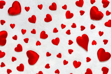 Card to St. Valentine's day with a frame of red textile hearts on a white background. Top view,...