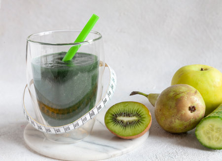 Close up of homemade green smoothie, fresh healthy organic food on white backgroundの写真素材