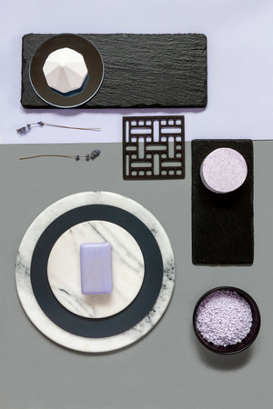 Modern trendy SPA and wellness concept with lavender bath salt and soap on natural stones plates....