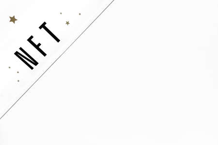 NFT inscription on white background. Close-up, top view, copy space.