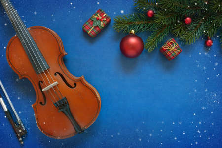 Old violin and fir-tree branches with Christmas decor. Christmas, New Year's concept. Top view,...