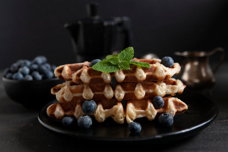 Croffle, trendy crispy korean baked goods, top view on dark background, selective focusの写真素材