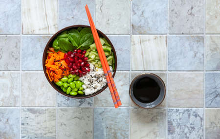 Pan Asian trendy Homemade vegetarian Poke Bowl with Rice, edamame, fresh vegetables and soy sauce,...