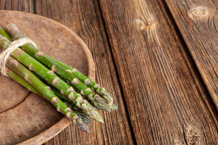 Fresh Asparagus Spears on a Wooden Tableの写真素材