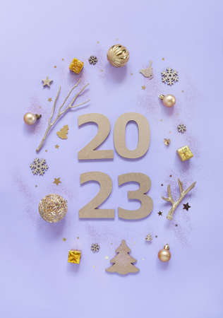2023 Year Golden Number Text on trendy lavender Background with festive decorationsの写真素材